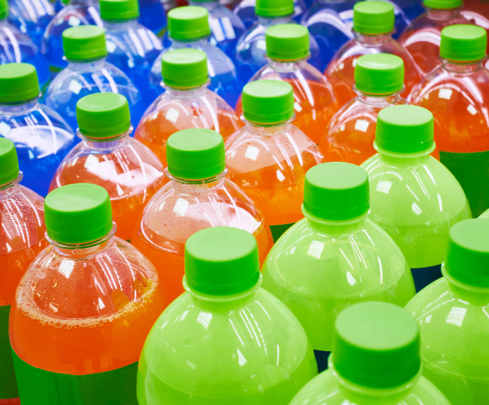 Blue, orange, and green drinks in plastic meant to show how food and beverage logistics are needed across multiple companies.