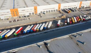 Image of multiple trucks lined up, each of which could benefit from 3pl shipment visibility.
