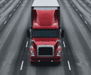 Red truck on road, facing forward.