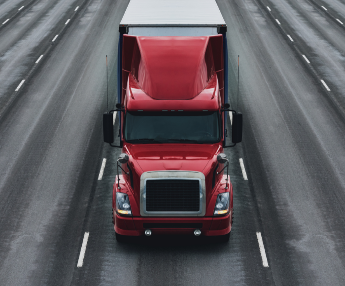 Red truck on road, facing forward.