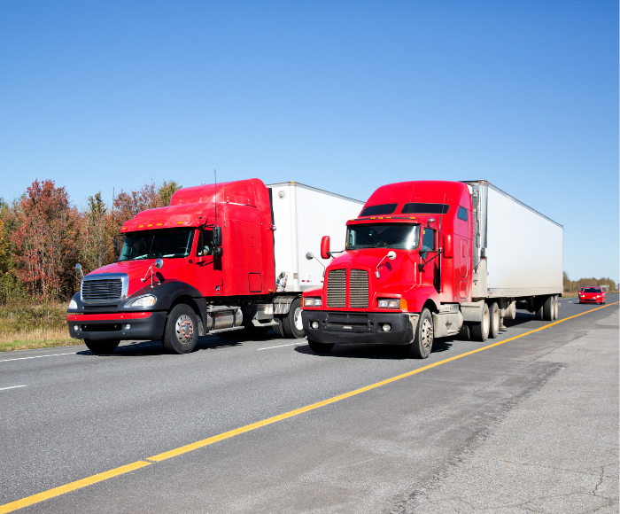 Two similar looking trucks meant to symbolically show the concept of chameleon carriers.