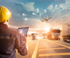 Picture of 3PL shipment visibility in action as man checks tablet to find location of trucks.