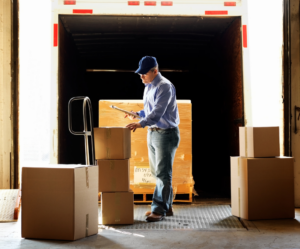 Man putting boxes in truck to symbolize freight LTL tracking.