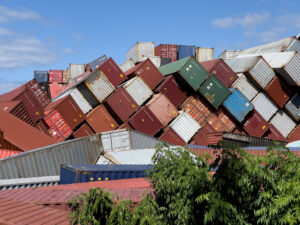 Damaged shipping containers, showing the importance of insurance for cargo shipping.
